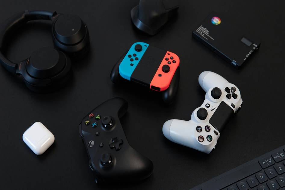 Nintendo Switch console with Pro controller and Joy-Con on gaming desk