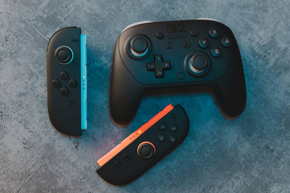 Official Nintendo Switch controllers displayed on a desk with dock and game cards